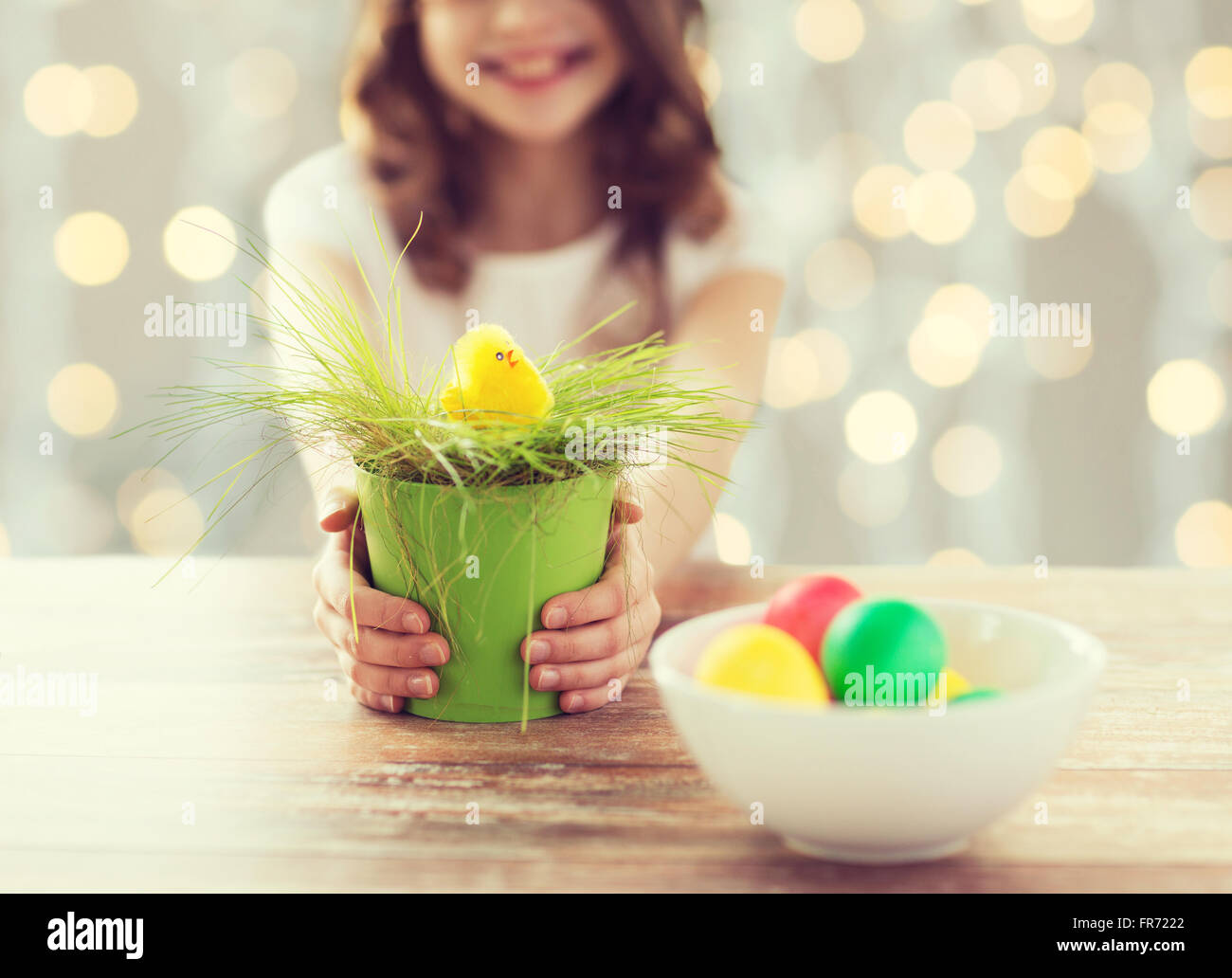 close up of girl holding pot with easter grass Stock Photo
