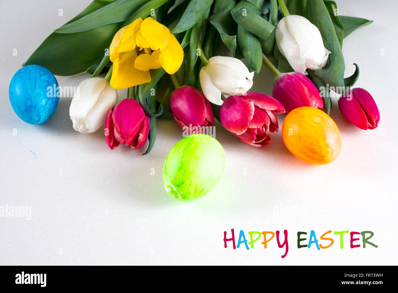 painted easter eggs with red, white and yellow tulips bouquet Stock ...
