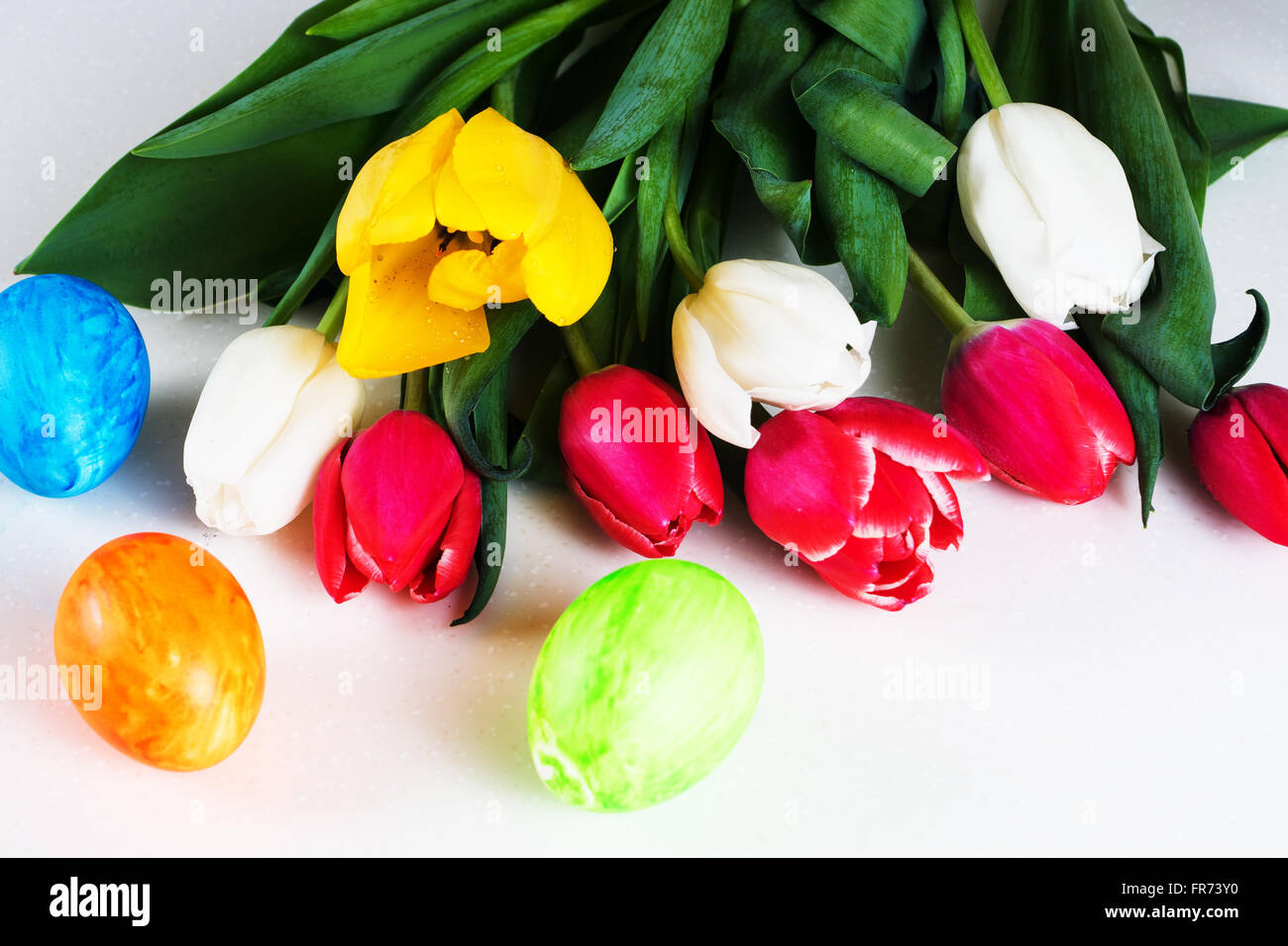 painted easter eggs with red, white and yellow tulips bouquet Stock ...