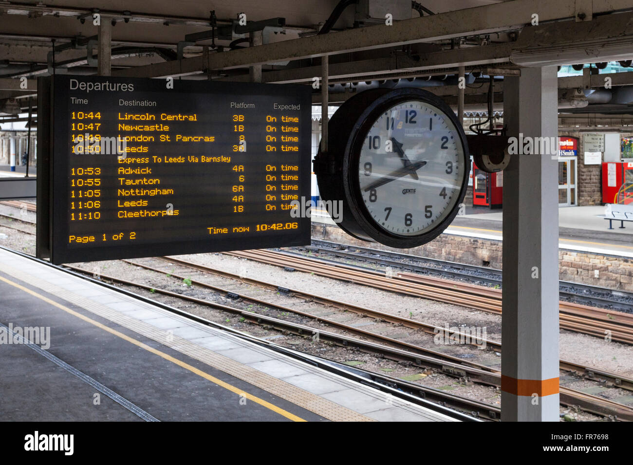 train departure board with times of train departures platform numbers and station clock sheffield station sheffield yorkshire england uk stock photo alamy