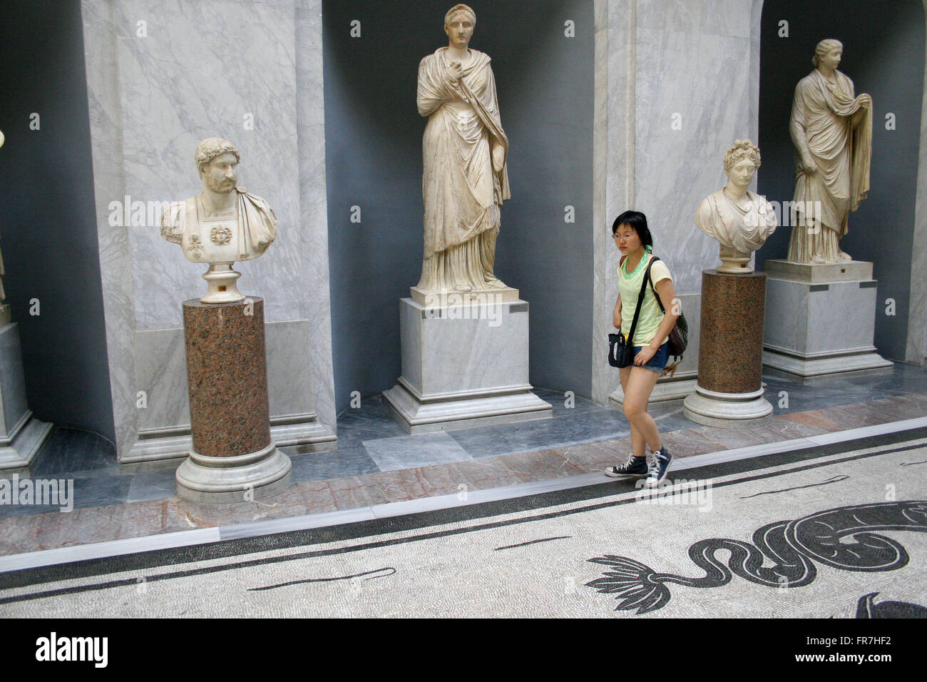 Chinese girl in museum looking at sculptures, Vatican Museum, Rome, Italy Stock Photo