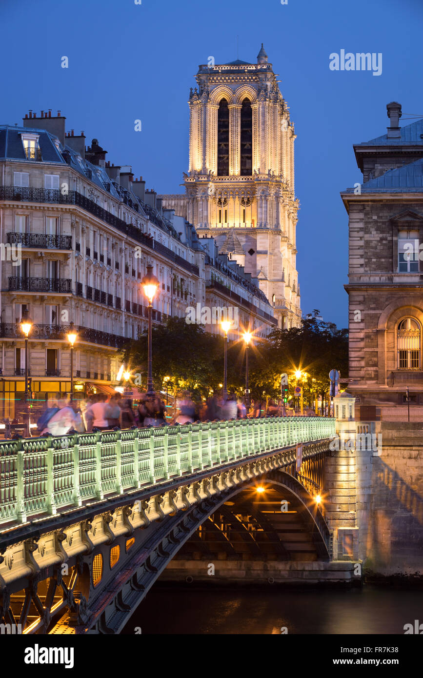 Pont d’Arcole and the towers of Notre Dame de Paris Cathedral illuminated at twilight. Ile de la Cite, Paris, France Stock Photo