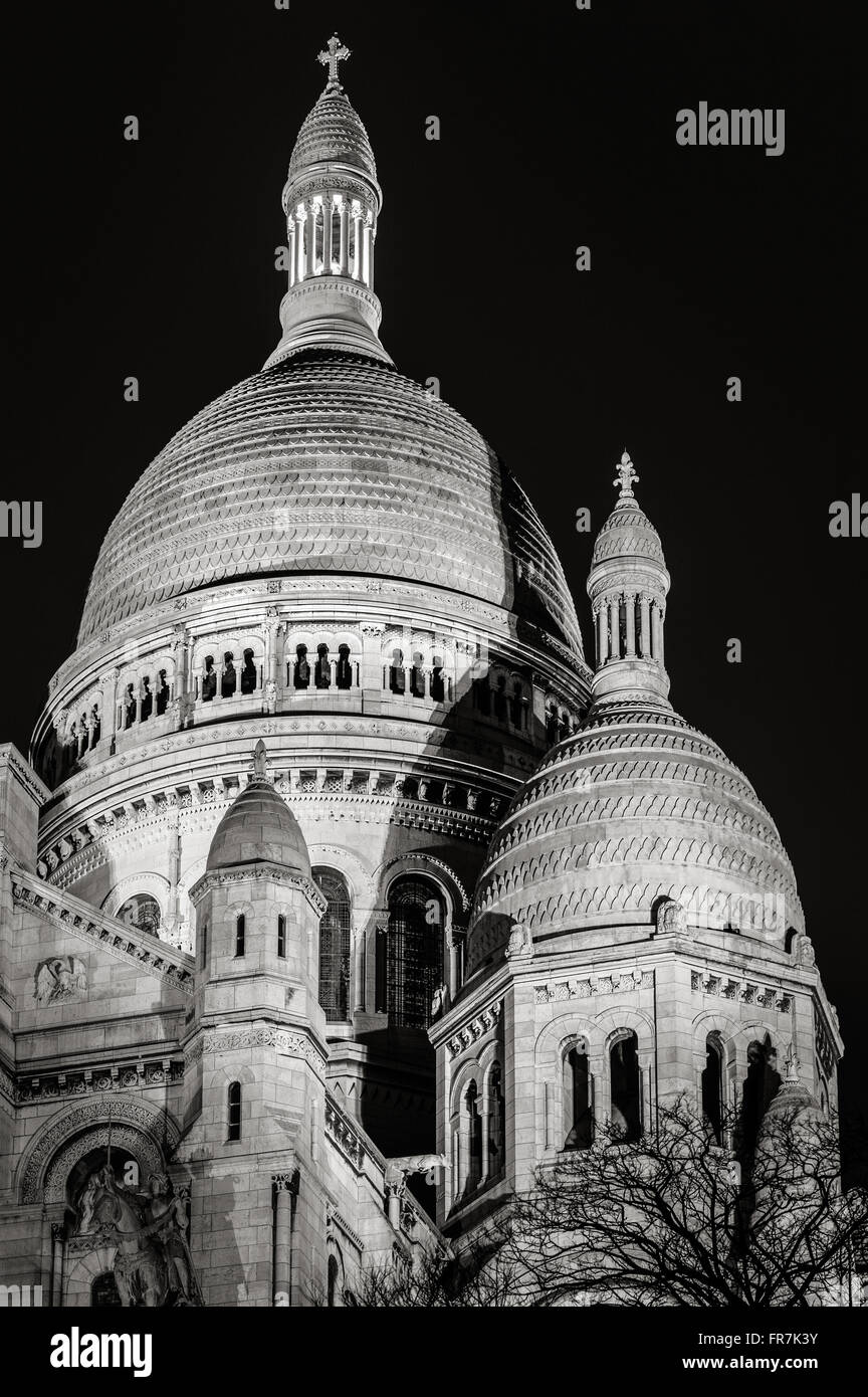 Architectural detail in Black & White of the Basilica of the Sacred Heart (Sacre-Coeur) illuminated at night in Montmartre Paris Stock Photo
