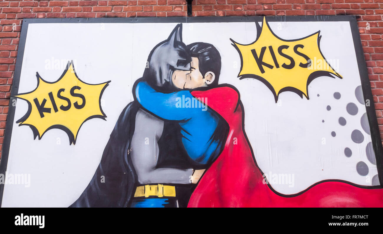 Mural of Batman and Robin kissing on wall of New Union Hotel on Canal Street in Manchester`s Gay village. Manchester. UK Stock Photo