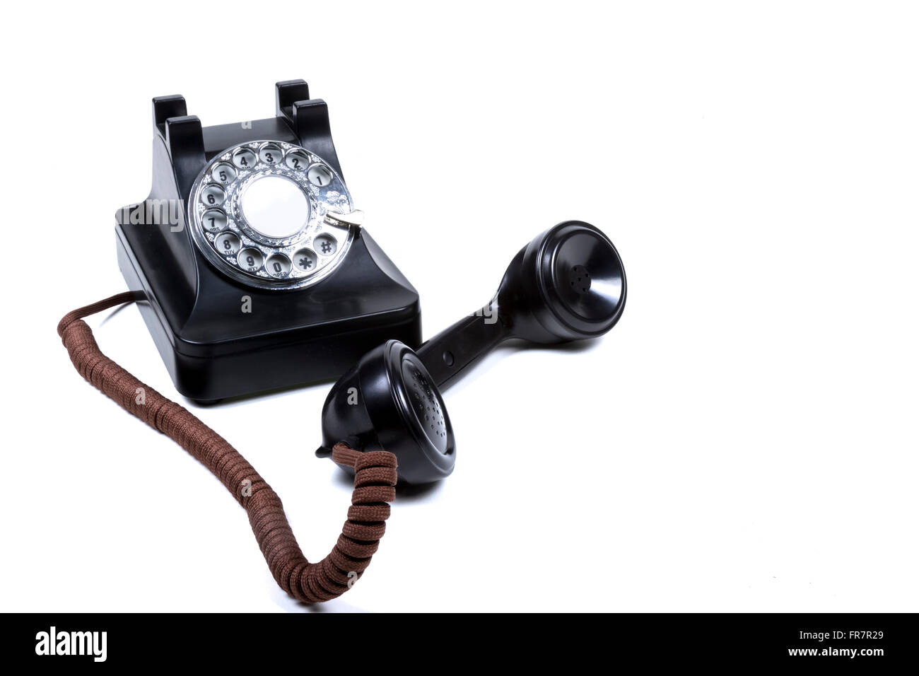 A Black Rotary Phone With The Receiver Off The Hook Stock Photo