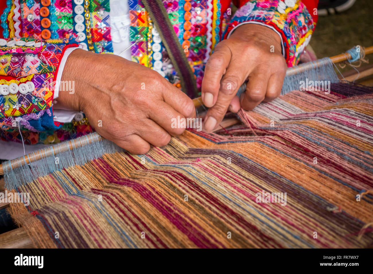 WASHINGTON, DC, USA - Woman from Cusco, Peru demonstrates weaving with backstrap loom (awana), during 2015 Smithsonian Folk Life Stock Photo