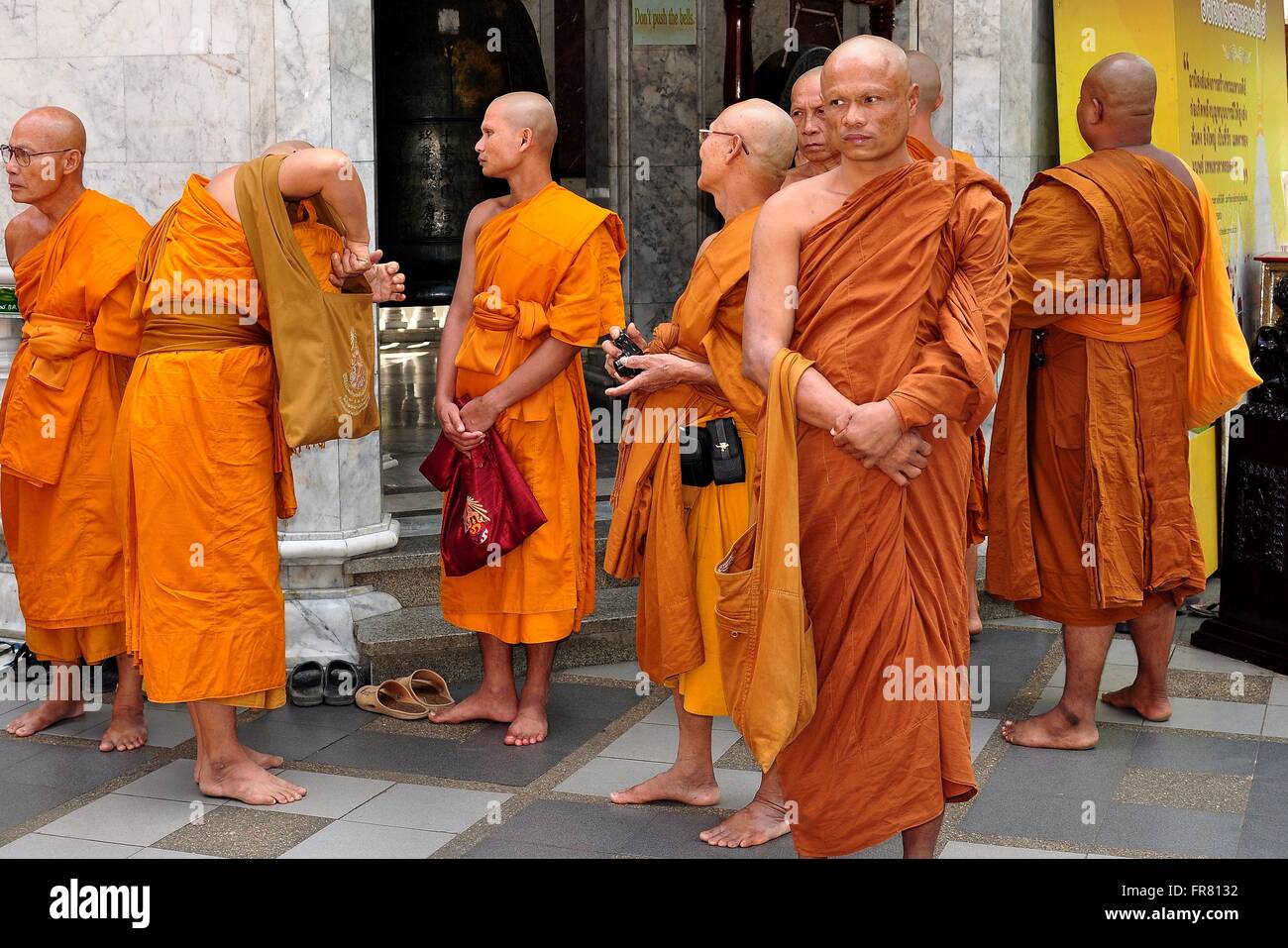 Chiang Mai, Thailand :   A group of monks with shaved heads dressed in traditional orange robes at Wat Doi Suthep Stock Photo