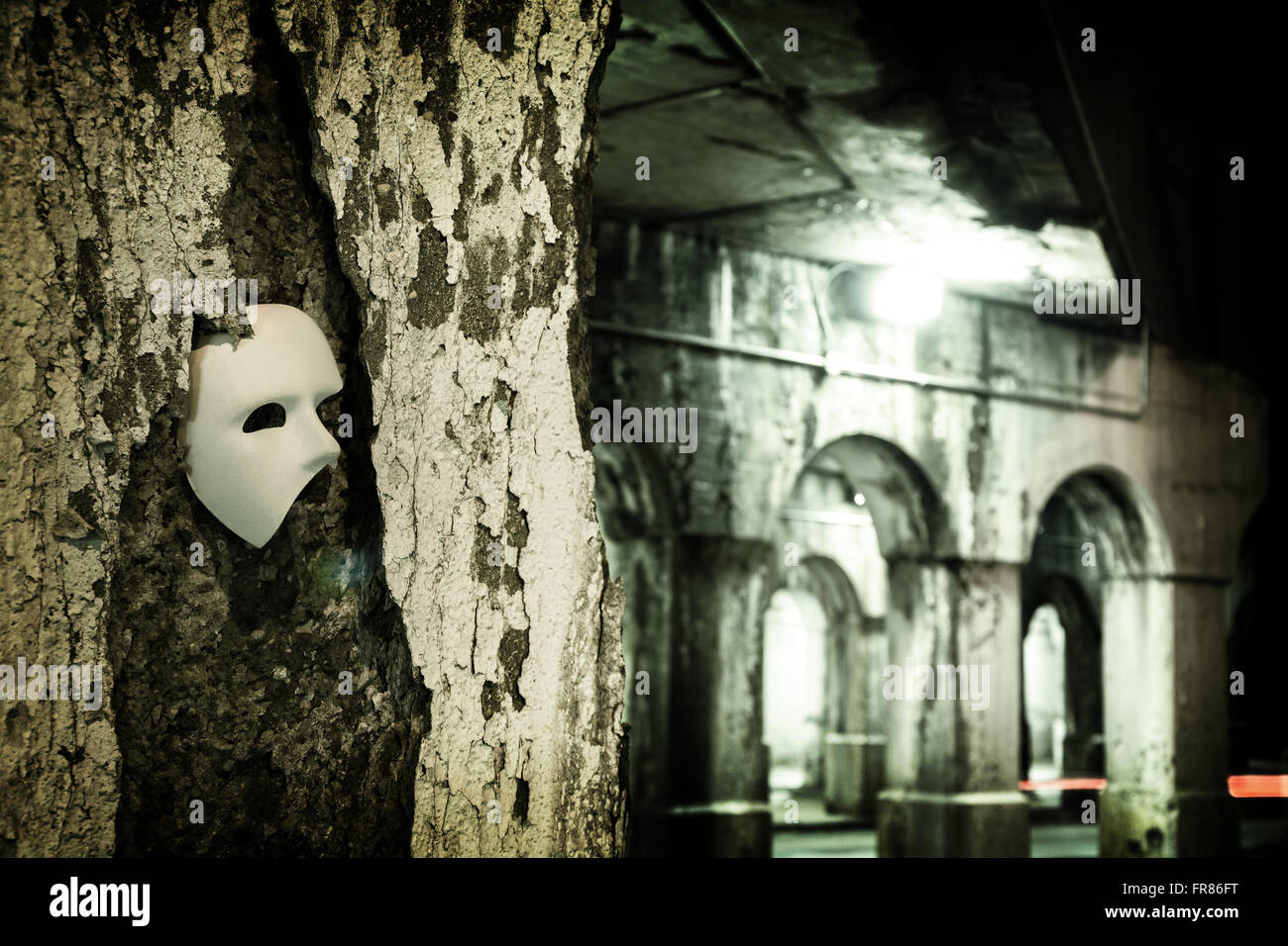 Lurking in the Shadows - Phantom of the Opera Mask in Dark Tunnel Stock Photo