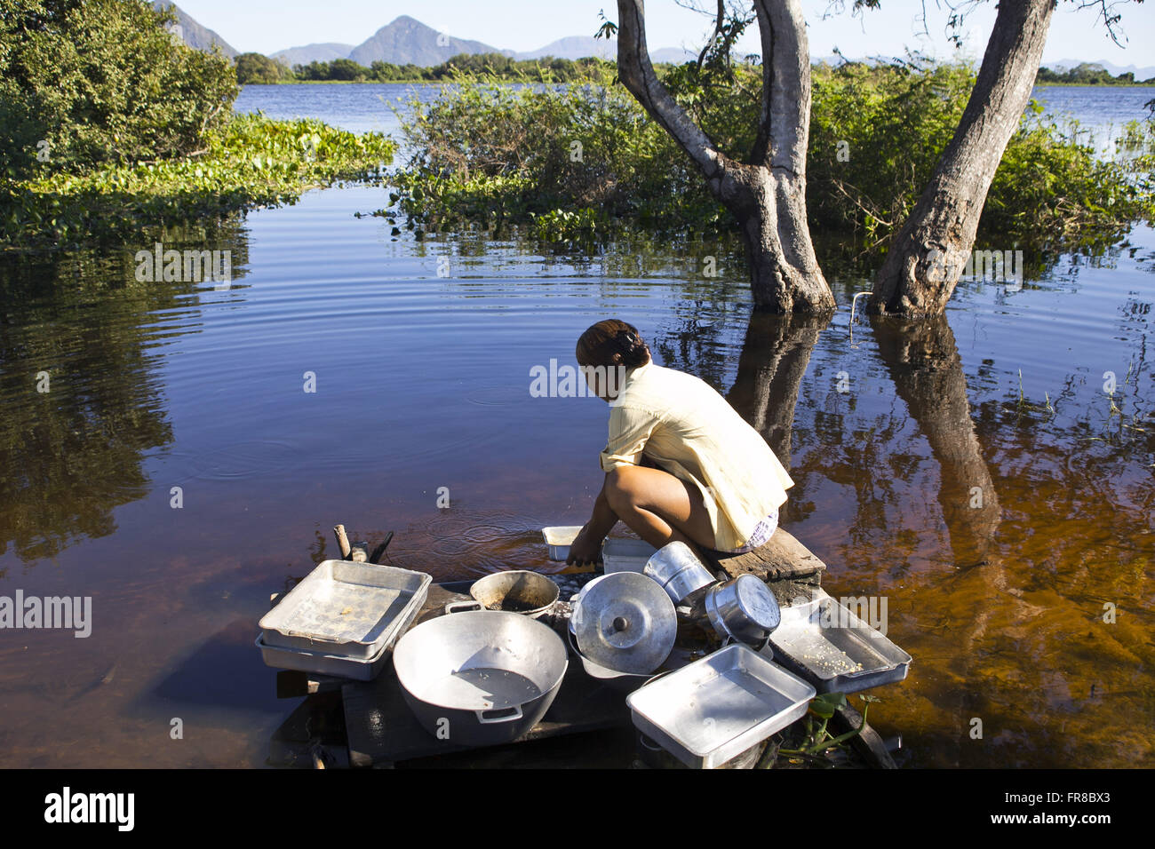 Riverside woman washing crazy on the River Paraguay Stock Photo