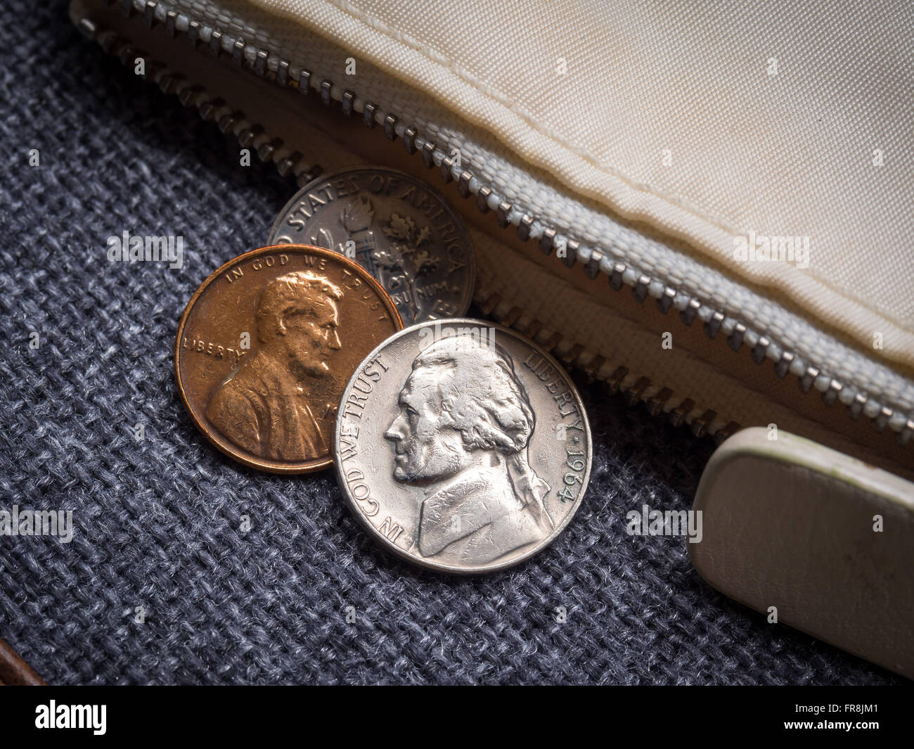US dollar coins placed outside the wallet. Stock Photo