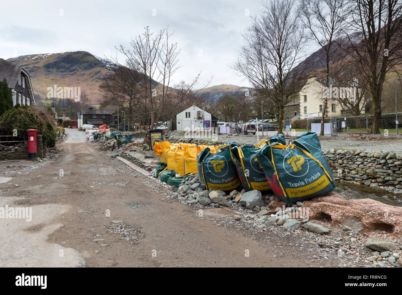 Emergency Makeshift Flood Defences Still Evident in the Village of Glenridding 3 Months after Flooding from Storm Desmond Caused Stock Photo