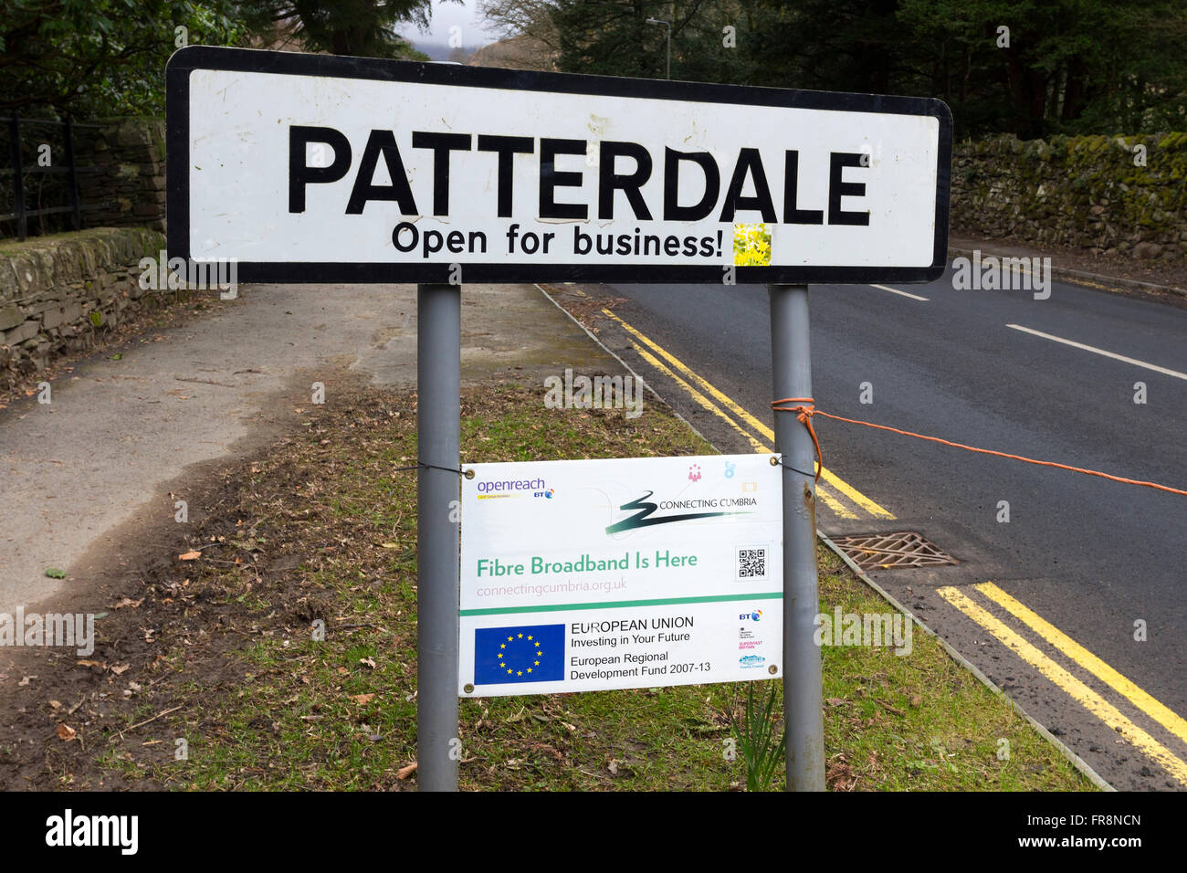 Weather Beaten Patterdale Open for Business Sign with BT Fibre Broadband Sign Underneath Highlighting European Union Investment, Stock Photo