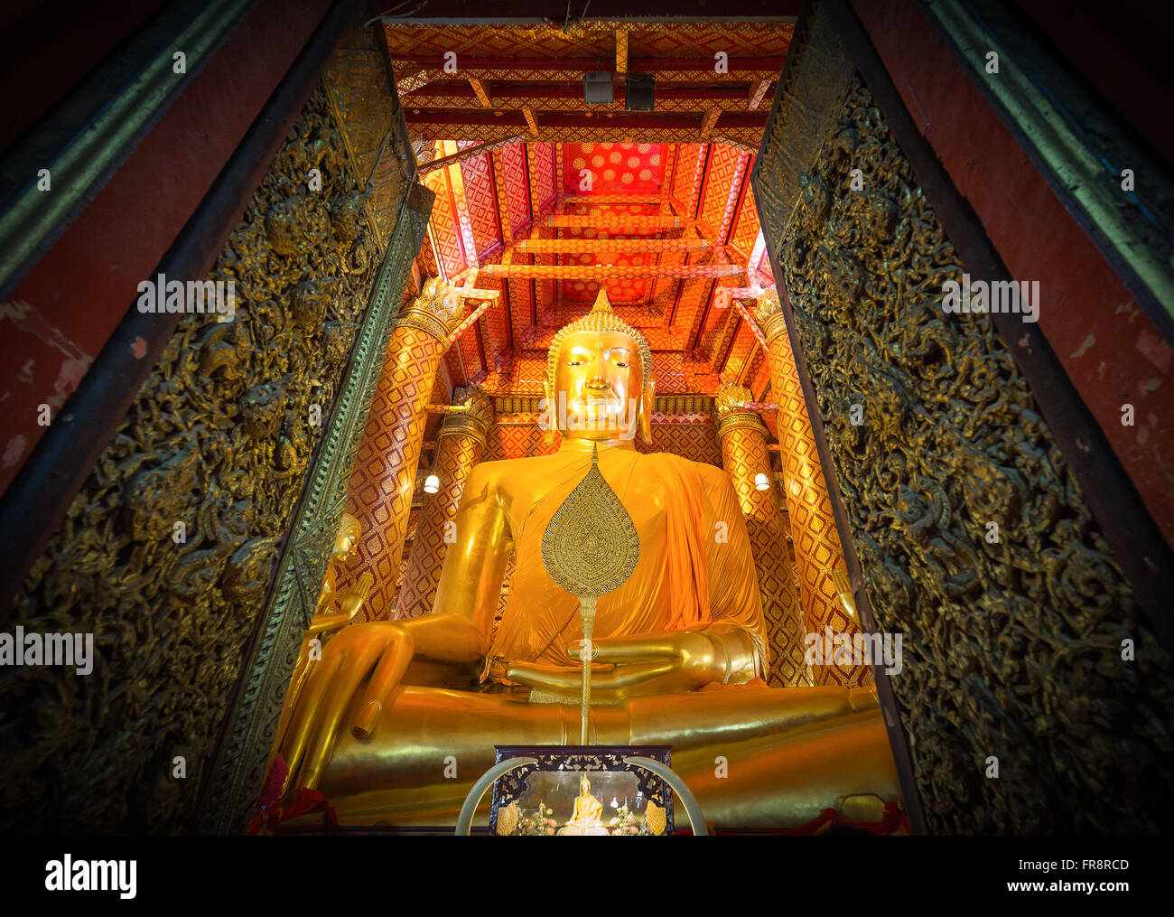 The gate open into the big gold buddha statue called Luang Pho To in chapel of Wat Phanan Choeng in Ayutthaya, Thailand. Stock Photo