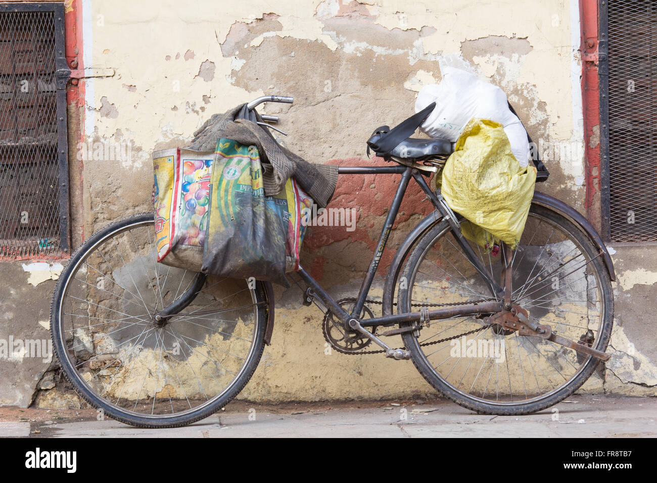 Asia, India, Uttar Pradesh, Agra,bicycle leaned on wall Stock Photo