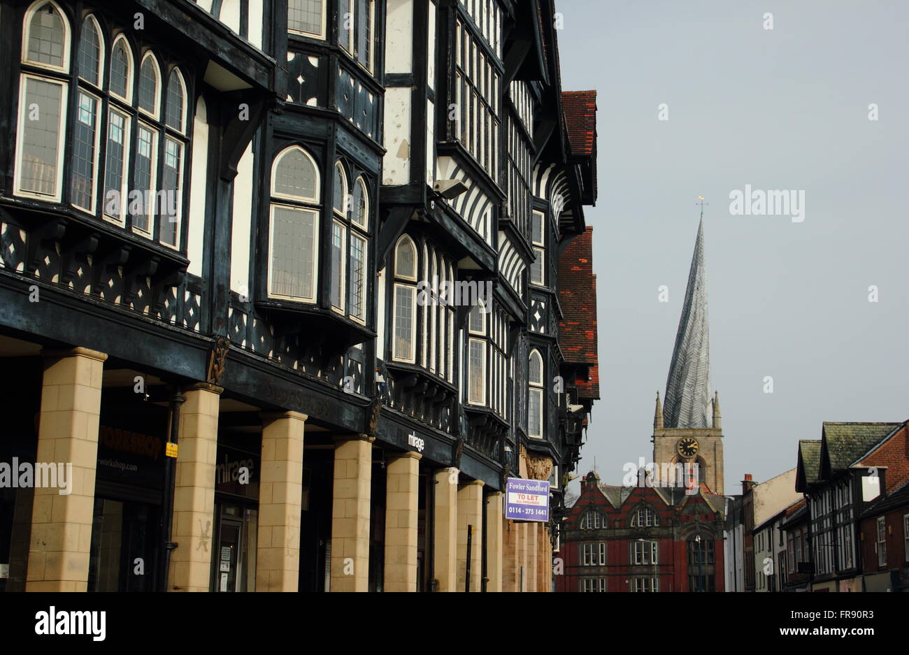 Black and white buildings on Knifesmithgate looking to the twisted spire of St Mary and All Saints Church, Chesterfield UK Stock Photo
