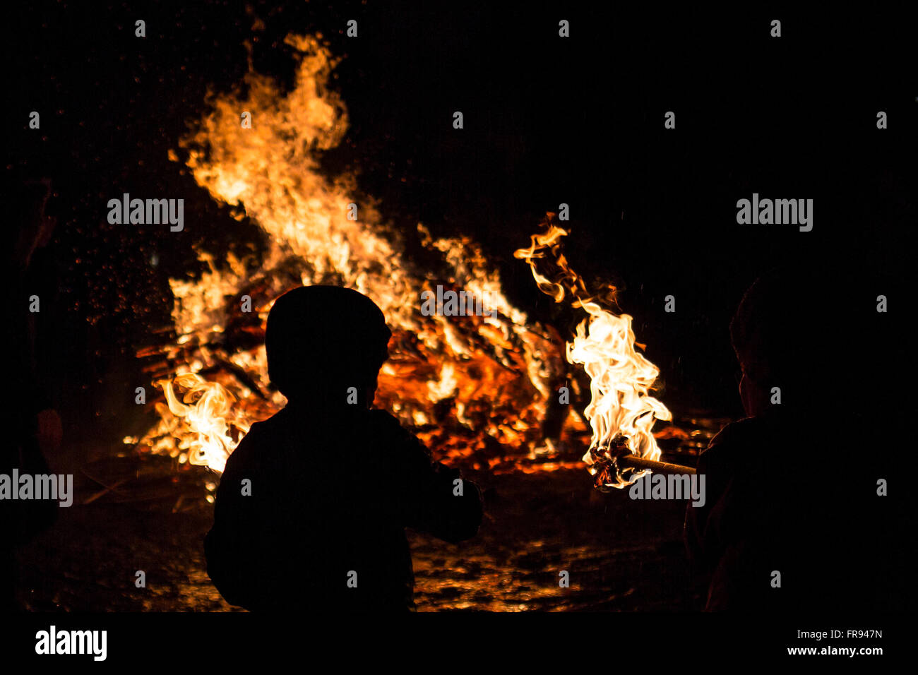 An young child is participating in a fire ritual during a celebration of Sirni Zagovezni. It is believed that evil spirits are c Stock Photo