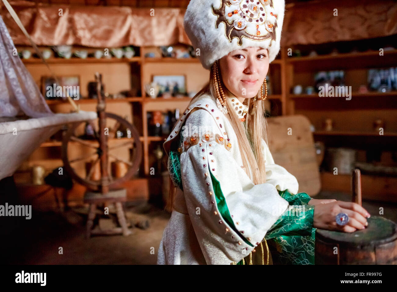 Young woman in traditional yurt dwelling. Stock Photo