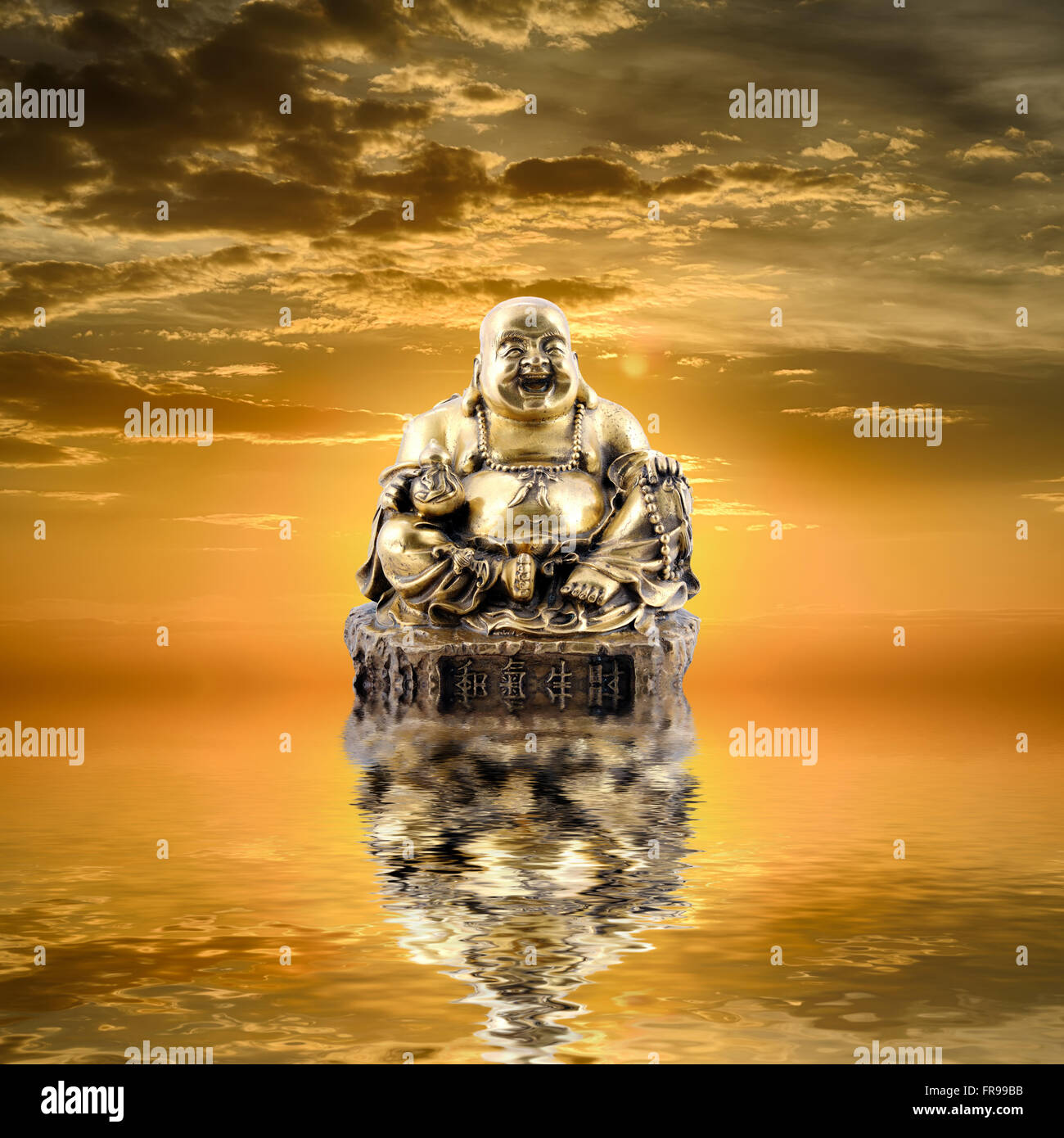 Feng Shui background. Laughing Buddha or Budai is reflected in water at  sunrise Stock Photo - Alamy