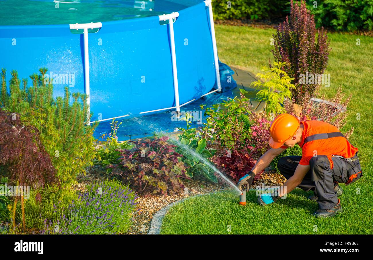 Curated visual reference: Caucasian Lawn Garden Technician In The Residential Garden With Photo Inspiration