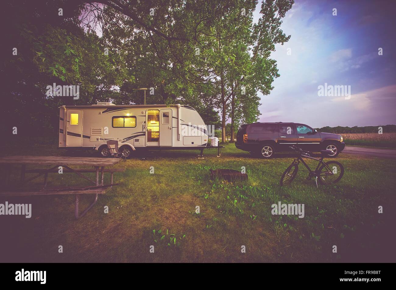 RV Camping Adventure. SUV Pulling Travel Trailer. Camper Journey Stock