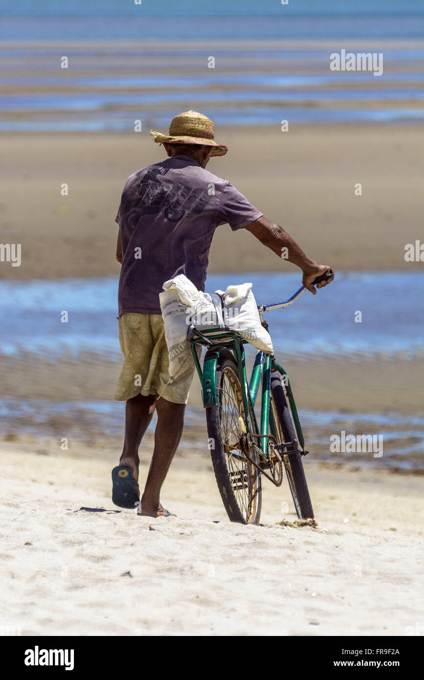 Rascal and his bike on the beach of Barra Grande Stock Photo