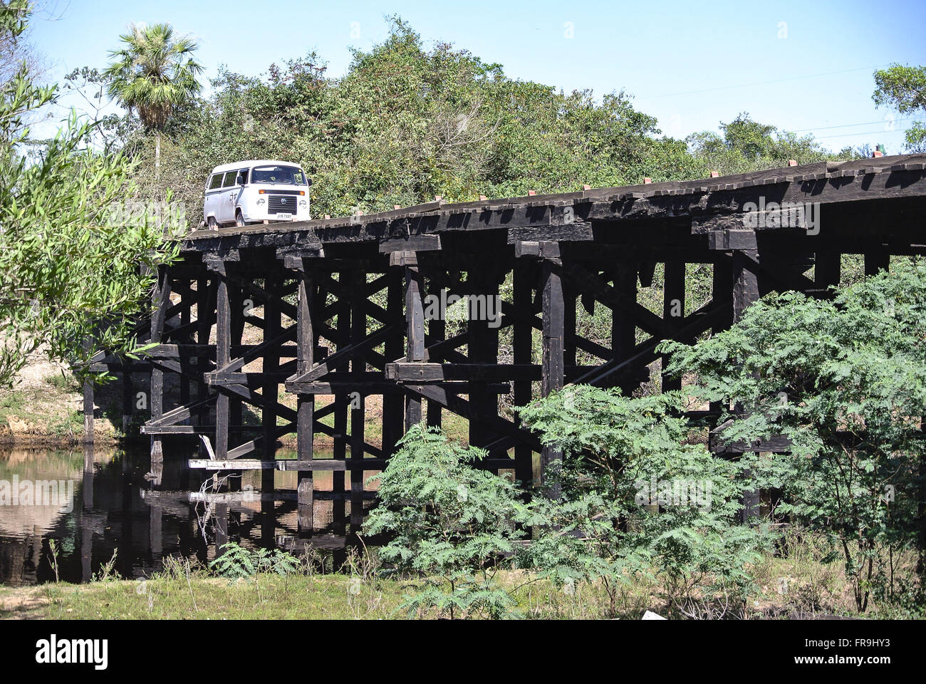 Van traveling at a wooden bridge in the Pantanal Park Road South Stock Photo