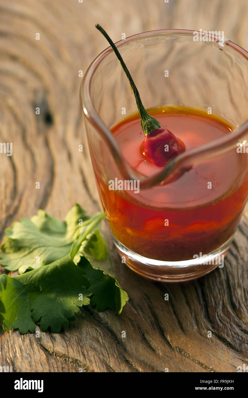 Pot with palm oil and chilli pepper Stock Photo