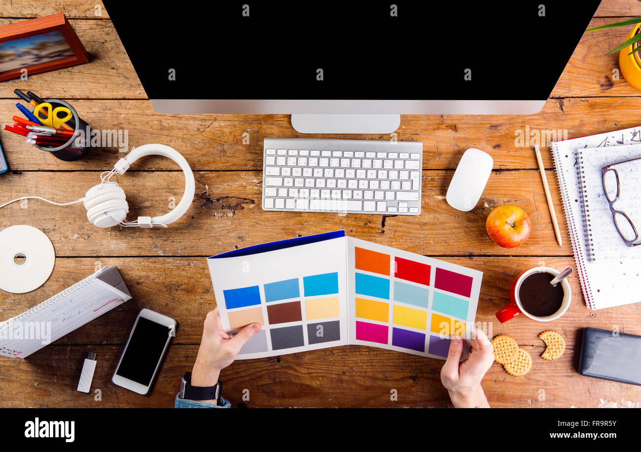 Designer at office desk working with color swatches Stock Photo - Alamy