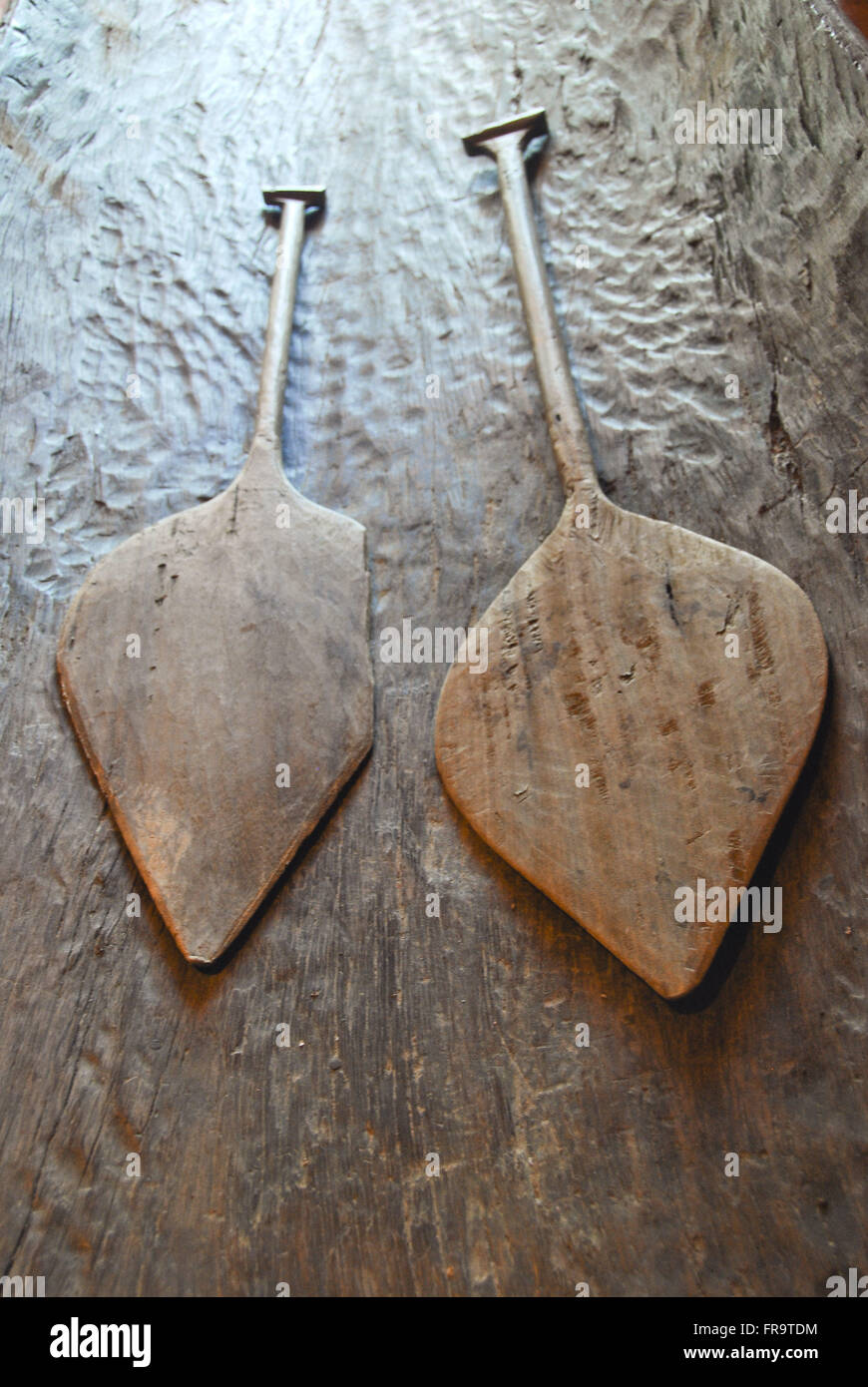 Wooden paddles carved with knife and machete - traditional crafts and local Stock Photo