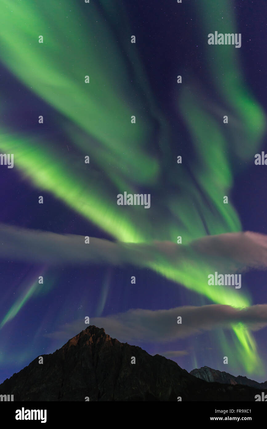 The aurora borealis fills the sky over Mt. Dillon in the Brooks Range north of Wiseman, Arctic Alaska. Stock Photo