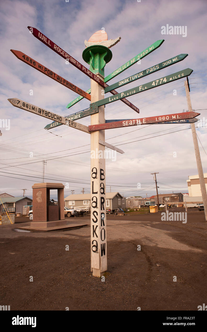 Direction signpost pointing to cities around the world from the streets of Barrow, North Slope, Arctic Alaska, Summer Stock Photo