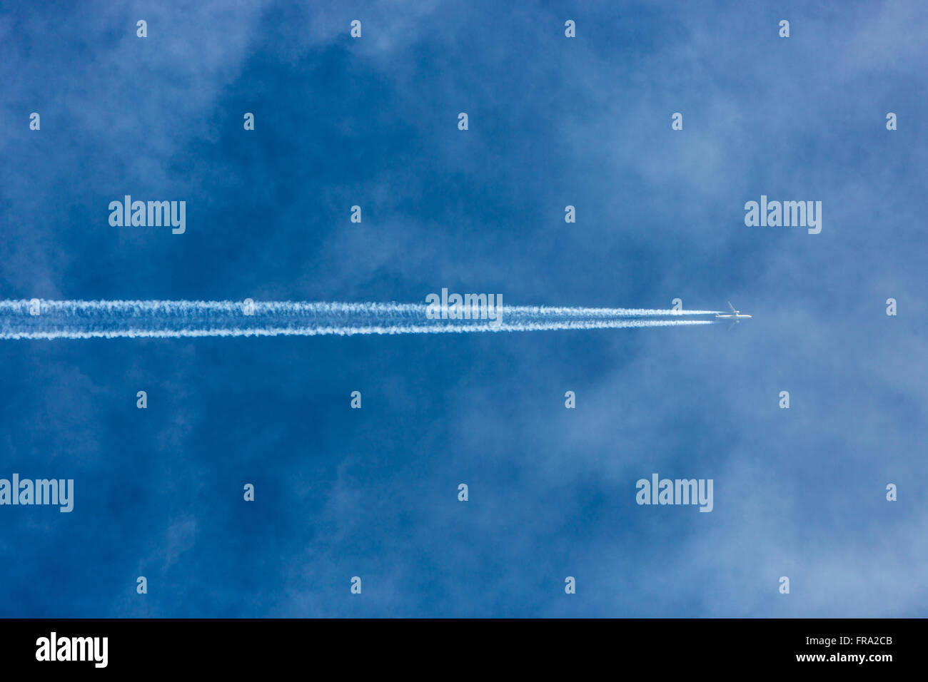 Aircraft con-trails in blue sky Stock Photo