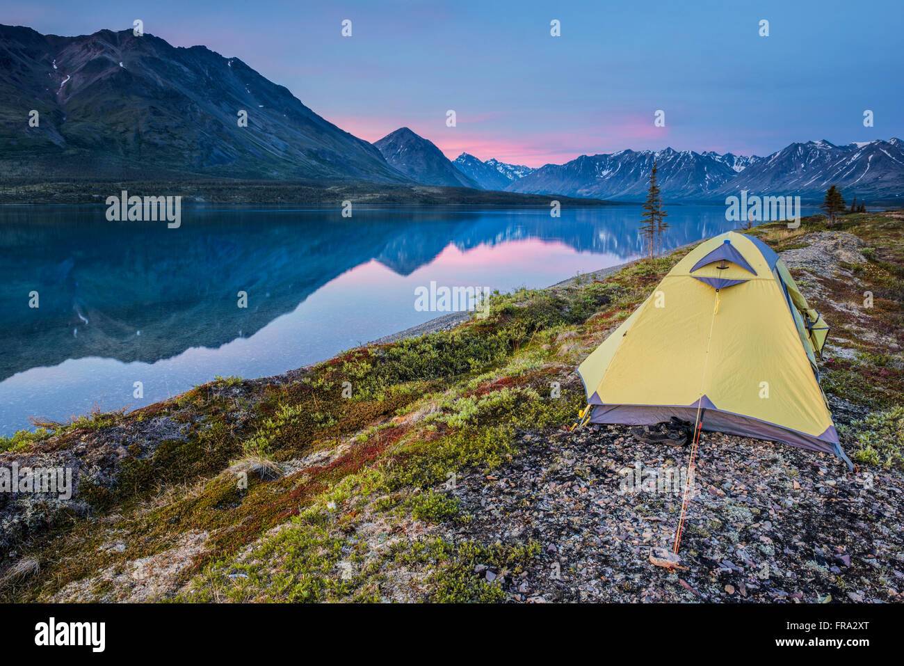 Scenic view of Lower Twin Lake with a backpacking tent in the foreground and sunset, Lake Clark National Park & Preserve, Southcentral Alaska Stock Photo