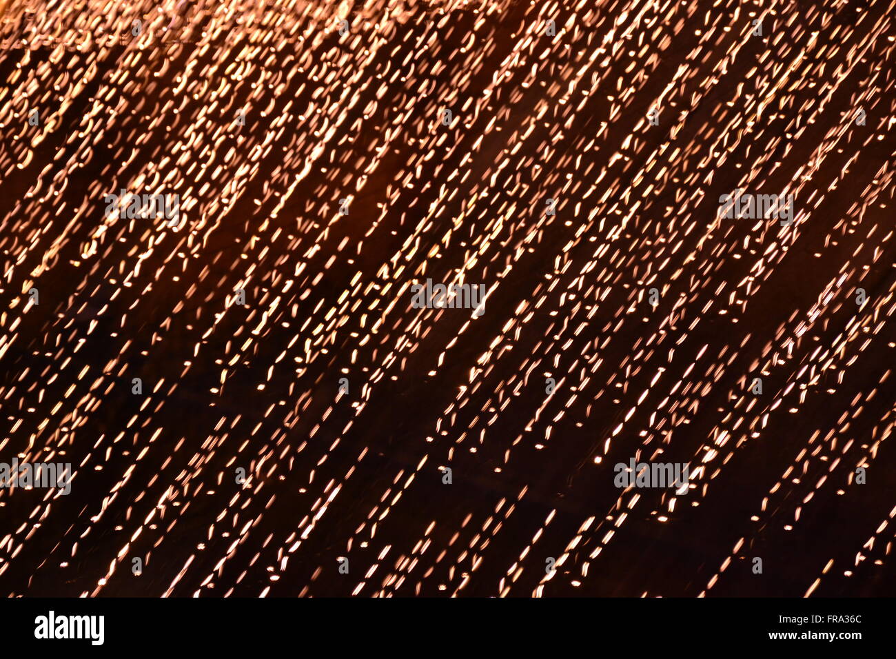 Falling golden sparks abstract background Stock Photo