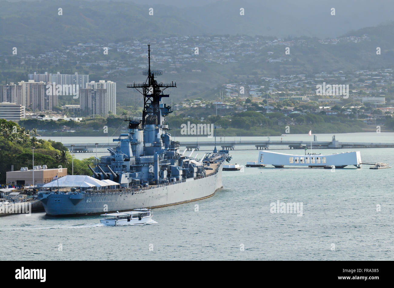The USS Missouri (BB-63) rests at berth in Pearl Harbor near the USS Arizona Memorial; Oahu, Hawaii, United States of America Stock Photo
