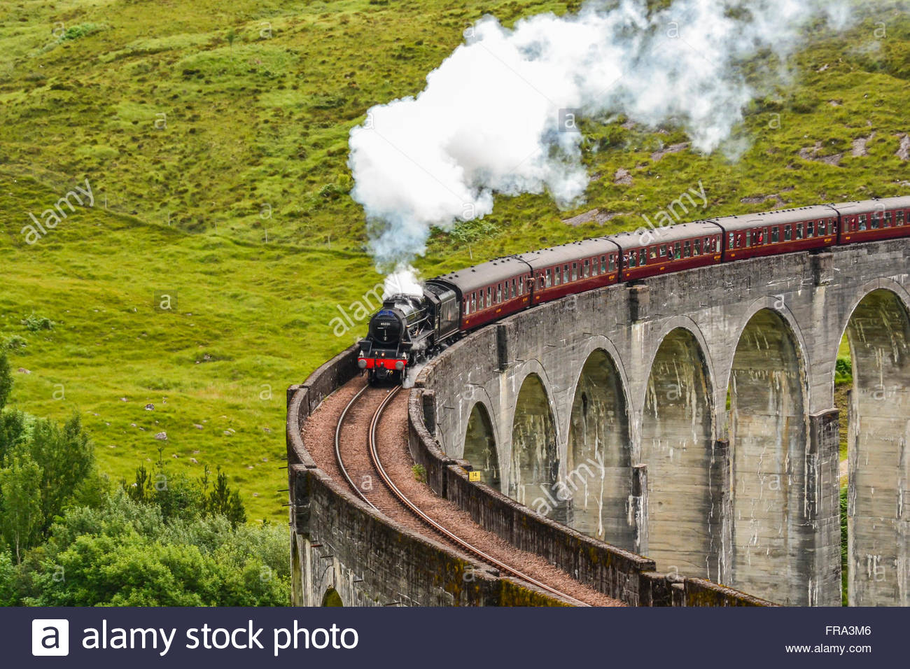 The Jacobite Steam Train Crosses The Glenfinnan Viaduct On Its Way