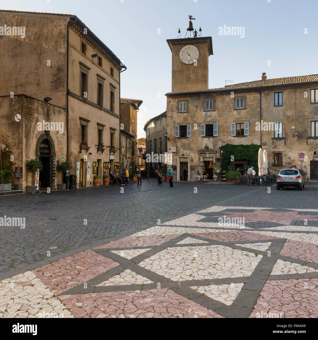 Clock tower and decorative stonework in star of david design on the street; Orvieto, Umbria, Italy Stock Photo