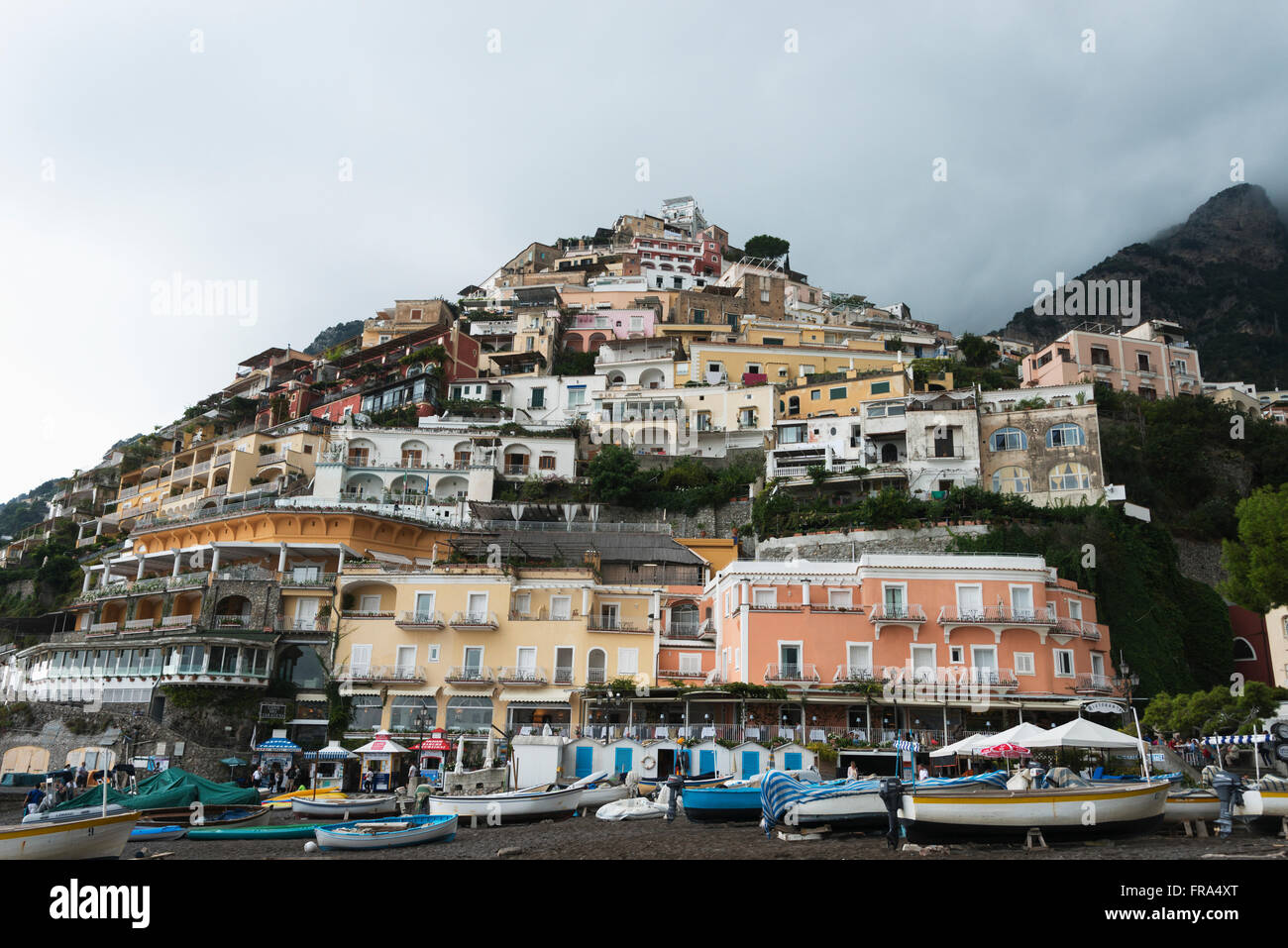 Houses on a hillside and boats on the shore along the Amalfi coast; Positano, Campania, Italy Stock Photo