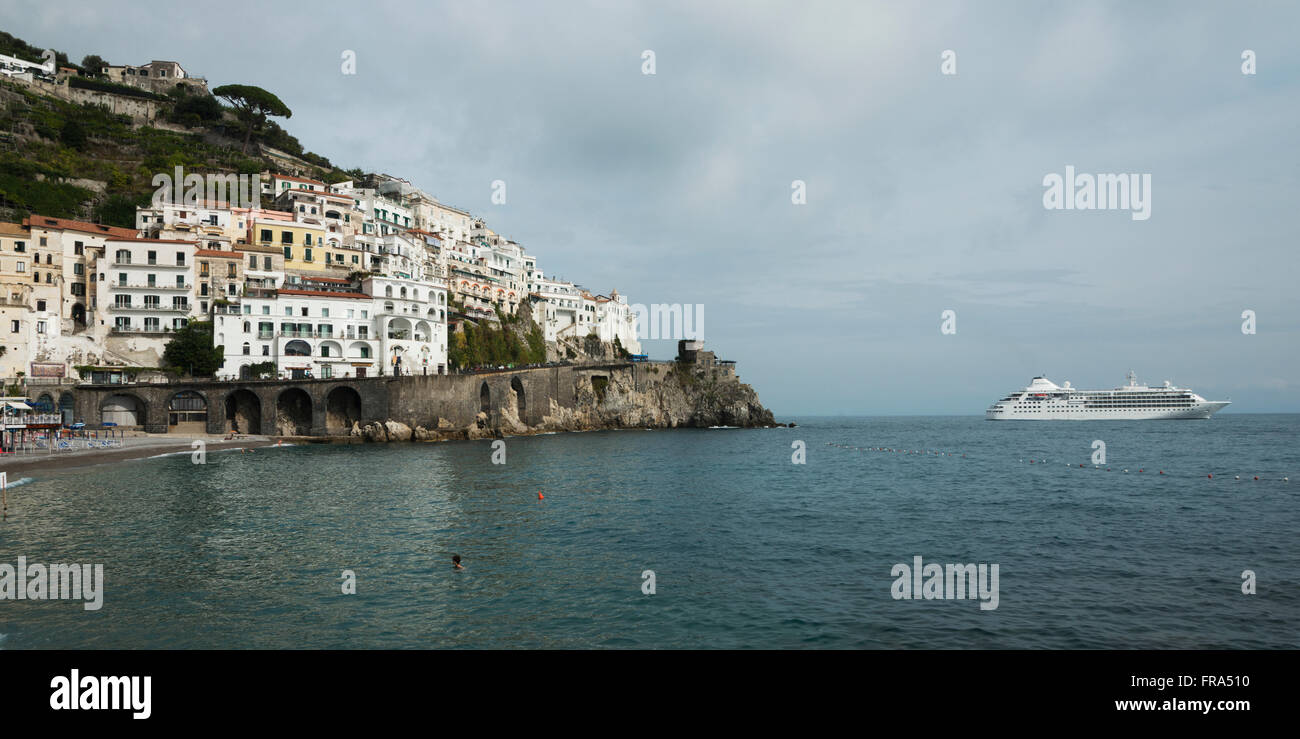 Buildings and a boat along the Amalfi coast; Amalfi, Campania, Italy Stock Photo