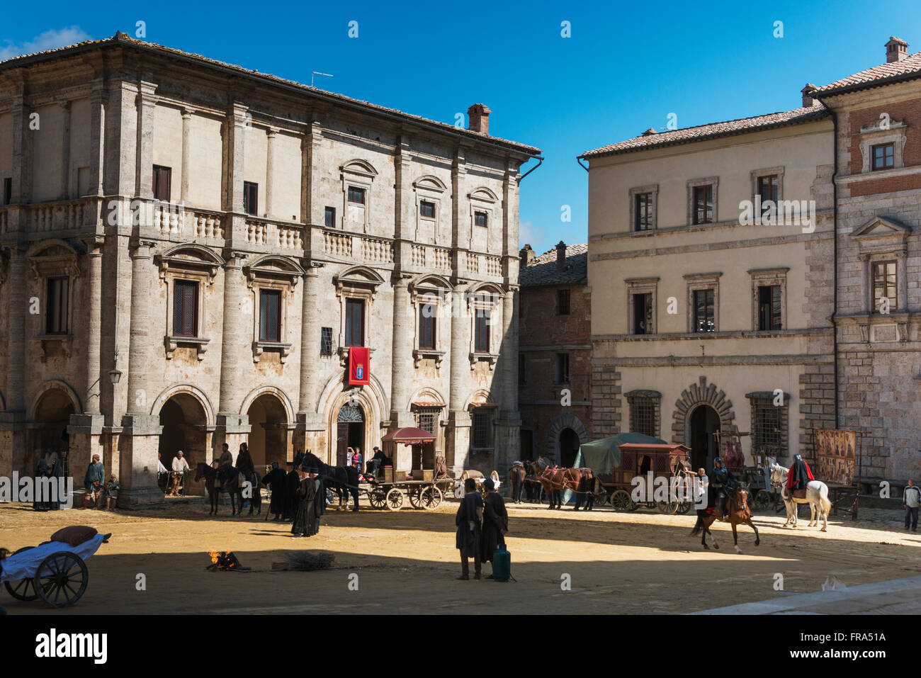 Pedestrians and horseback riders in a town square; Montepulciano, Toscana, Italy Stock Photo