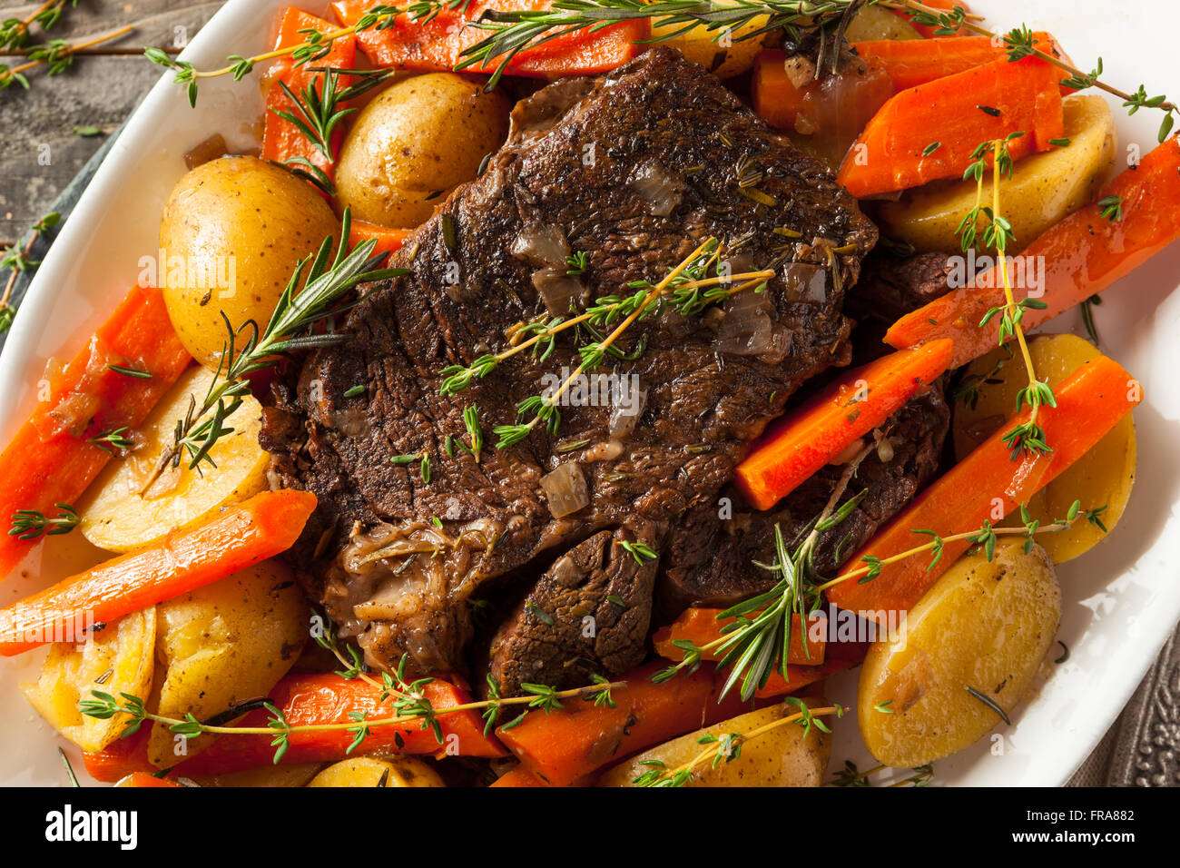 Homemade Slow Cooker Pot Roast with Carrots and Potatoes Stock Photo
