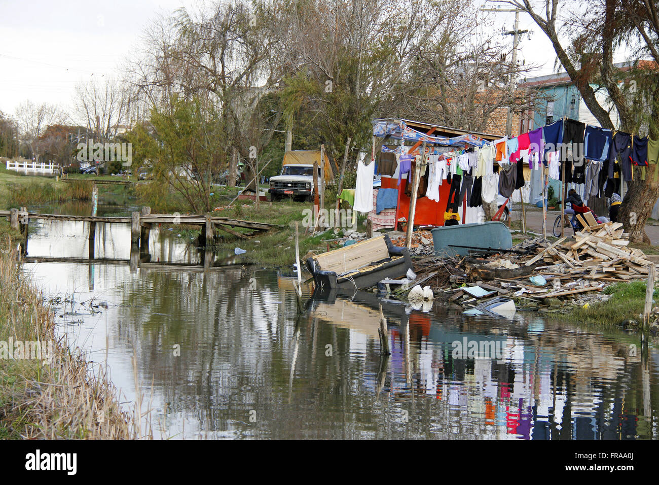 Irregular occupation and debris thrown into canal that flows into the Lagoa dos Patos - the city of Rio Grande Stock Photo