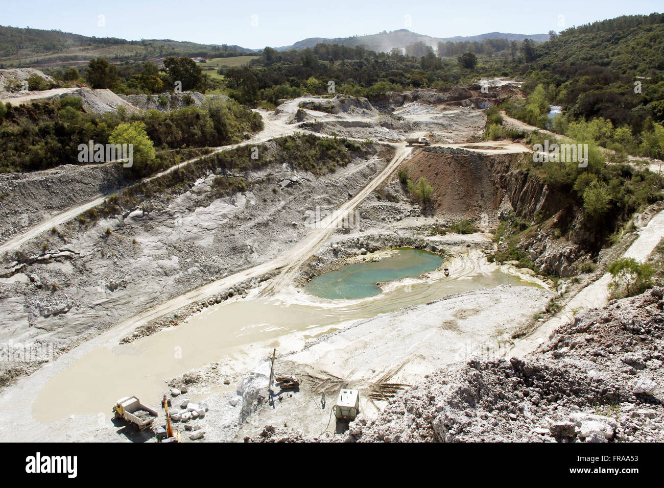 Crater formed by extraction of limestone rock in the open pit Stock Photo