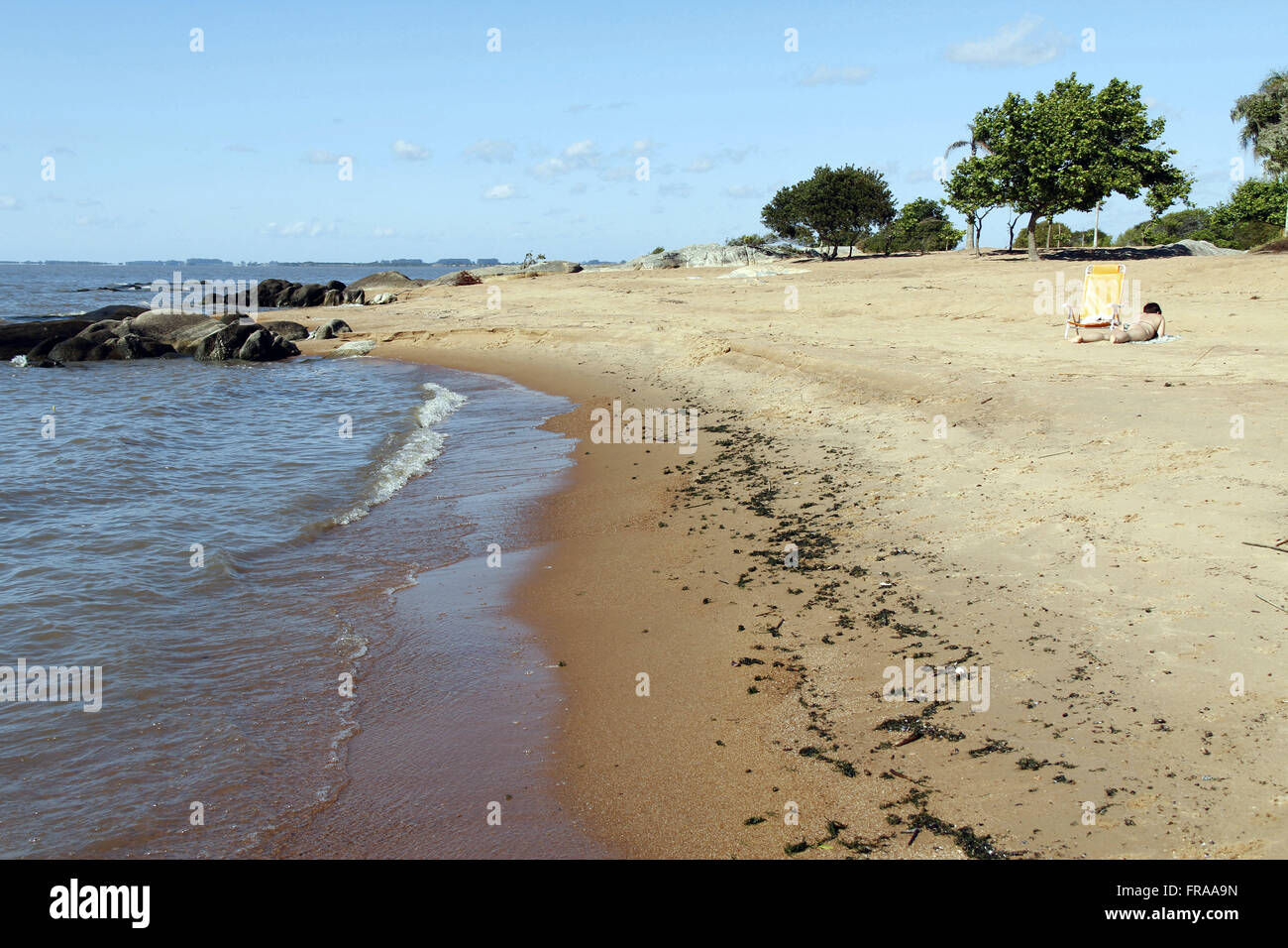 Bather sunning on the banks of the Lagoa dos Patos in Sao Lourenco do Sul - RS Stock Photo