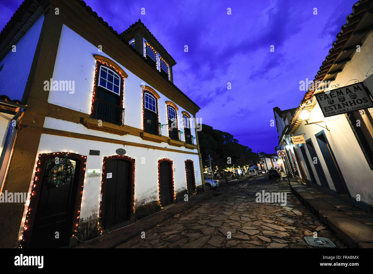 Colonial houses decorated with lights at night Stock Photo