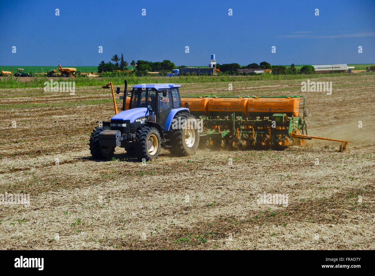 Tractor with planter performing planting grain in the countryside Stock Photo