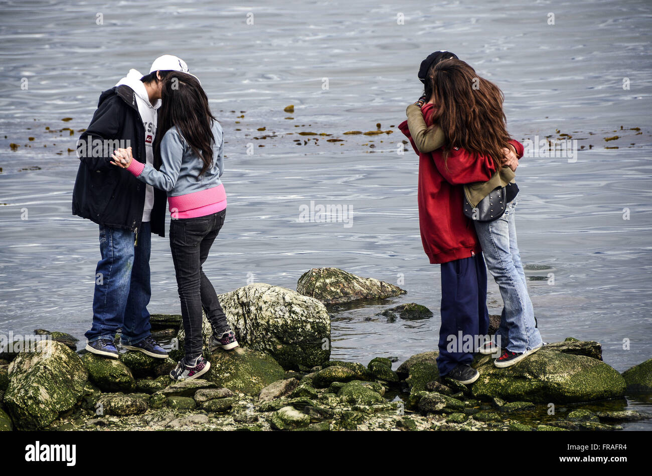 Couples embraced and teenagers kissing near the port city Stock Photo