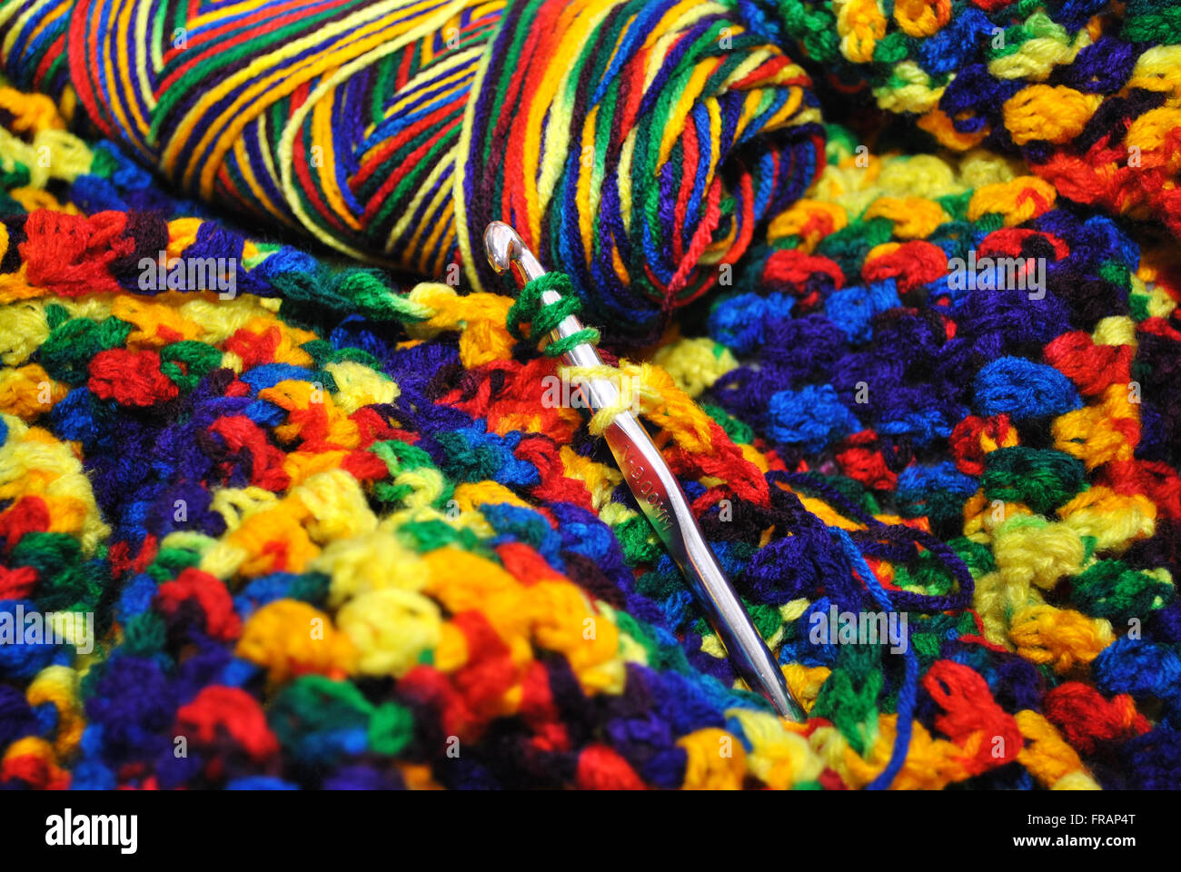 Crocheting with Rainbow Colored Yarn Stock Photo - Alamy