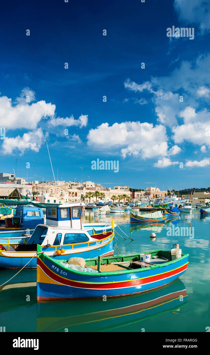 marsaxlokk harbour and traditional mediterranean fishing boats in malta island Stock Photo