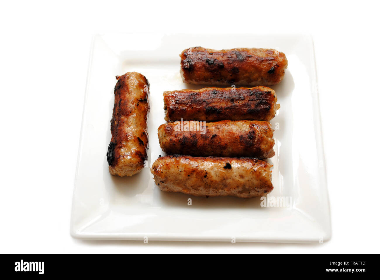 Cooked Breakfast Sausage Served on a White Plate Stock Photo